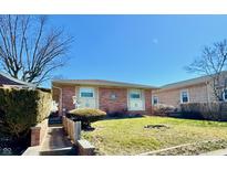 Charming single-story brick home featuring a well-maintained lawn and a cozy, inviting entrance at 75 S 11Th Ave, Beech Grove, IN 46107