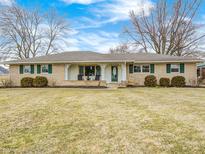 Charming single-story home with a well-maintained lawn and inviting porch with lots of light at 8010 E County Road 700 N, Brownsburg, IN 46112