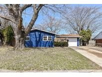 Charming single-story home featuring a blue exterior, well-maintained lawn and inviting curb appeal at 8026 Roy Rd, Indianapolis, IN 46219