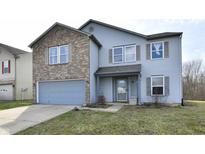 Charming two-story home features a brick accent, attached garage, and well-maintained lawn at 8630 Aylesworth Dr, Camby, IN 46113