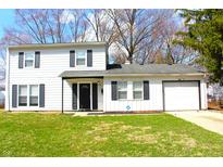 Charming two-story home with a well-maintained lawn and classic curb appeal enhanced by dark shutters and door at 9238 Celtic Ct, Indianapolis, IN 46235