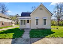Charming cottage-style home with a well-maintained lawn, awning details, and inviting curb appeal at 93 Walnut St, Indianapolis, IN 46227