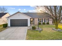 Charming single-story home with a brick facade, well-maintained lawn, and a two-car garage at 17309 Pine Wood Ln, Westfield, IN 46074