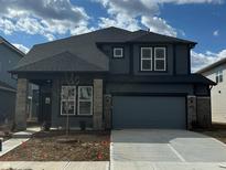 New two-story home featuring stone accents, a two-car garage, and a well-manicured lawn under a partly cloudy sky at 2758 Penn Ave, Plainfield, IN 46168