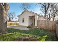 Charming home with a well-maintained lawn, gravel driveway and an American flag at 3225 S Rybolt Ave, Indianapolis, IN 46221