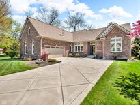 Beautiful brick home with a well-maintained lawn, concrete driveway, and attached garage at 3559 Towne Dr, Carmel, IN 46032