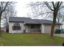 Charming ranch-style home featuring a covered porch and attached two-car garage at 3982 Tamara Way, Franklin, IN 46131