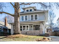 Charming two-story home with a well-manicured lawn and a welcoming front porch at 4055 Broadway St, Indianapolis, IN 46205