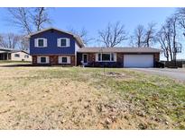 Charming two-story home with brick accents and a well-maintained front yard on a sunny day at 425 Conduitt Dr, Mooresville, IN 46158