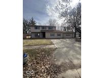 Two story home with attached two car garage and large, mature trees at 5155 Overland Ct, Indianapolis, IN 46268