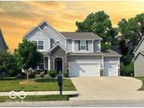 Charming two-story home features a stone entryway, manicured lawn, and a two car garage at 655 Bracknell Dr, Avon, IN 46123