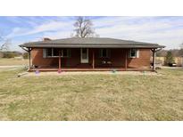 Inviting brick home featuring a spacious front porch, perfect for enjoying the outdoors at 6900 W Georgetown Rd, Columbus, IN 47201