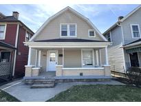 Charming home featuring a covered front porch and well-maintained exterior with neutral siding at 745 W 25Th St, Indianapolis, IN 46208