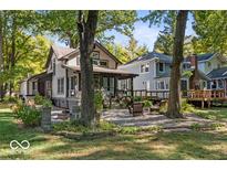 Charming two-story home with a covered porch and landscaped front yard, perfect for relaxing outdoors at 7513 Terrace Beach, Indianapolis, IN 46240