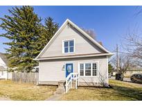 Charming house featuring light siding, a blue front door, and a well-maintained front yard at 821 S Lebanon St, Lebanon, IN 46052