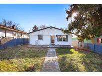Charming single-story home featuring a brick facade, a well-manicured lawn, and a walkway to the front door at 821 S Worth Ave, Indianapolis, IN 46241