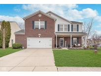 Charming two-story home with a brick facade, attached garage, and well-manicured front lawn at 8335 S Shady Trail Dr, Pendleton, IN 46064