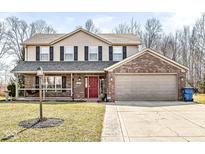Charming two-story home featuring a brick and siding exterior with a welcoming front porch and two-car garage at 10111 Ironway Dr, Indianapolis, IN 46239