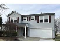 Two-story home featuring light-gray siding, bright white trim, and a white two-car garage at 10622 Howe Rd, Fishers, IN 46038