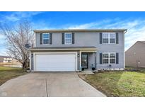 Charming two-story home featuring a two-car garage and gray vinyl siding at 1129 Spend A Buck Ct, Whiteland, IN 46184