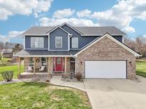 Charming two-story home with a brick and siding exterior, complemented by a welcoming front porch at 12121 N Berling Dr, Mooresville, IN 46158