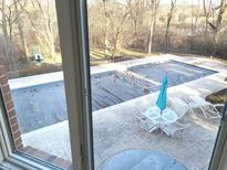 View of the covered pool and surrounding patio area, complete with an umbrella-shaded table set at 12227 Redgold Run, Carmel, IN 46032