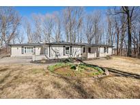 Charming white brick home with black shutters and a well-manicured lawn at 2408 E Stafford Pl, Martinsville, IN 46151