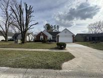 Charming single-story home features a manicured lawn, brick accents, and an attached two-car garage at 245 Suncrest Dr, Greenwood, IN 46143