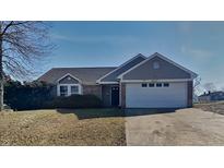 Charming single-story home featuring a two-car garage and a well-maintained lawn at 2617 N Temple Ave, Indianapolis, IN 46218