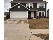 Charming two-story home featuring a two-car garage, well-maintained lawn, and classic architectural details at 298 Rocky Rd, Greenfield, IN 46140