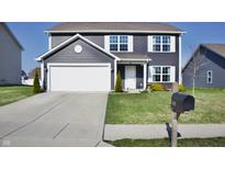 Charming two-story home with a well-manicured lawn and a two-car garage at 298 Rocky Rd, Greenfield, IN 46140