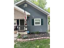 Charming home featuring a cozy porch, updated siding, and meticulous landscaping for enhanced curb appeal at 3308 Schofield Ne Ave, Indianapolis, IN 46218