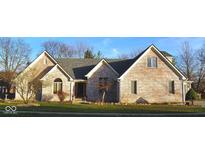 Well-maintained, light brick home showcasing manicured lawn, mature trees and a modern roof at 37 Trotters Run, Brownsburg, IN 46112
