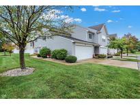Well-maintained townhouse with attached garage and a lush green lawn at 451 Filmore Dr, Westfield, IN 46074