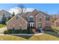 Stately two-story brick home featuring manicured landscaping and a welcoming entrance at 5517 Westbourne Ct, Greenwood, IN 46143