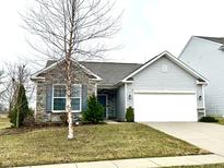 Charming single-story home featuring stone accents, vinyl siding, an attached two-car garage, and well-manicured landscaping at 5757 Pebblebrooke Rd, Whitestown, IN 46075