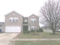 Charming two-story brick home with a manicured lawn and attached garage at 6651 Sonesta Dr, Indianapolis, IN 46217