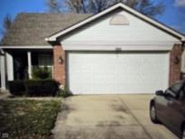 Charming single-Gathering home featuring a two-car garage and well-maintained landscaping at 7128 Moon Ct, Indianapolis, IN 46241