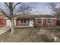 Charming brick ranch home with a well-maintained front yard and classic architectural details at 7602 E 34Th Pl, Indianapolis, IN 46226