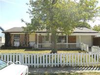 Charming single-story home with a welcoming front porch and white picket fence at 8445 Montery Rd, Indianapolis, IN 46226