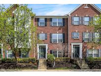 Charming brick townhome featuring classic architectural details and well-maintained landscaping at 918 Rosalind Pl, Carmel, IN 46032