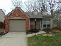 Charming single-story home with brick accents, attached garage, and well-maintained lawn and tidy landscaping at 9688 Alexander Ln, Fishers, IN 46038