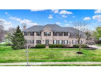 Spacious two-story home with a well-manicured lawn and traditional brick facade at 11427 Burkwood Dr, Carmel, IN 46033