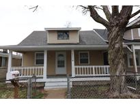 Charming single-story home features a welcoming front porch, neutral siding, and well-maintained landscaping at 1154 Bacon St, Indianapolis, IN 46227