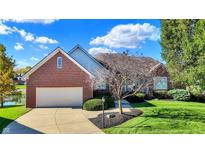 Charming brick home with an attached garage and a well-manicured lawn and mature trees in a desirable neighborhood at 11832 Stoney Bay Cir, Carmel, IN 46033