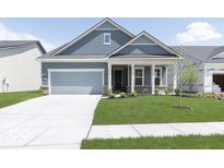 Charming single-story home with a well-manicured lawn and a covered front porch at 14859 Amber Light Dr, Westfield, IN 46074