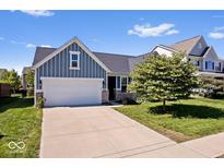 Charming single-Gathering home featuring blue siding, a two-car garage, and a well-manicured lawn at 15773 Eastpark Dr, Noblesville, IN 46060