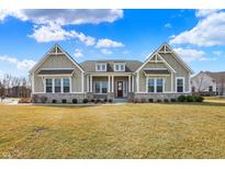 Charming home featuring a manicured lawn, stone accents, and inviting entrance at 16544 Gaither Ct, Westfield, IN 46074
