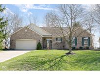 Charming ranch home featuring a brick exterior, attached garage, and well-maintained lawn and landscaping at 1667 Decourcy Ct, Franklin, IN 46131
