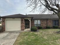 Charming single story brick home with attached garage, and mature landscaping in a quiet neighborhood at 1755 N Wellesley Commons, Indianapolis, IN 46219